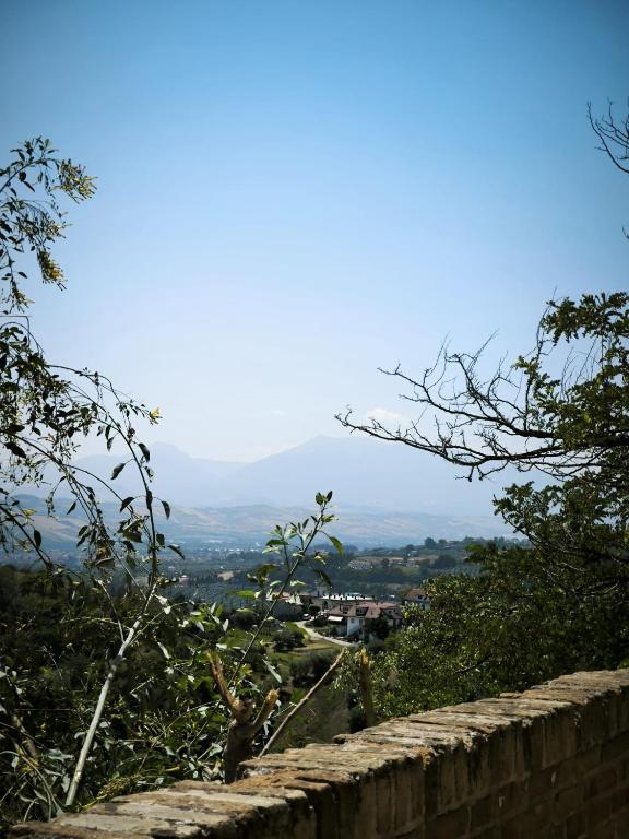 a stone wall with a view of a mountain at Due Orizzonti in Monsampolo del Tronto