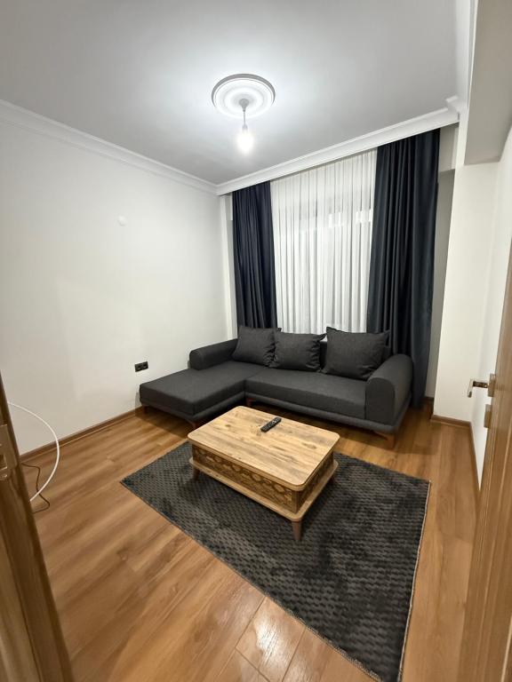 a living room with a couch and a coffee table at suite palace in Kapullu