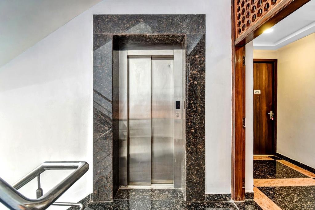a elevator in a building with a marble floor at Super Townhouse All In One in kolkata
