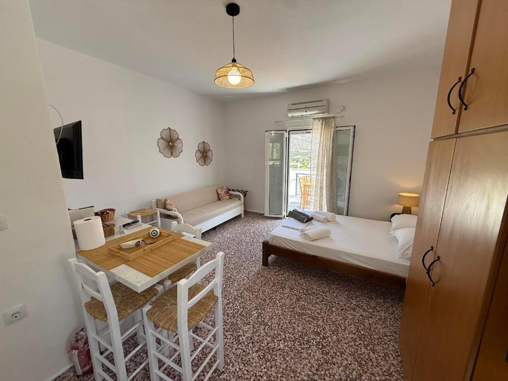 a living room with a table and a couch at Nion Stays in Katapola