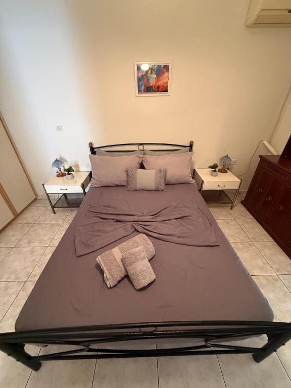 a bed with two towels on it in a bedroom at Velinora House in Rafina