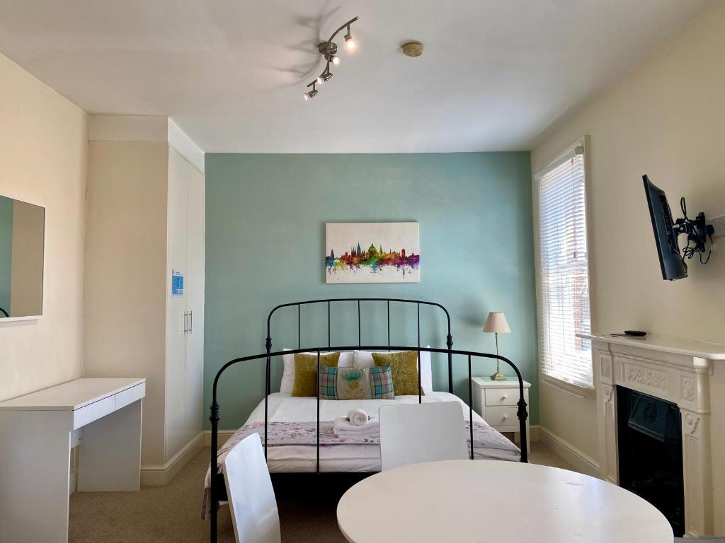 a bedroom with a bed and a table and chairs at Noa Residence in Oxford