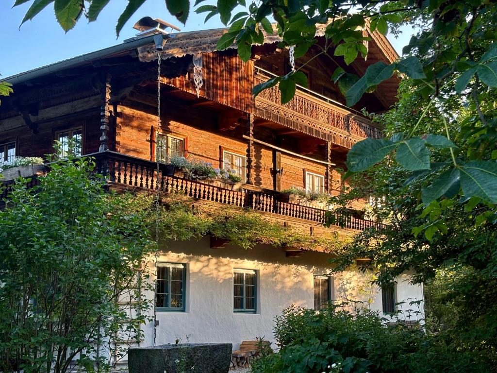 a large wooden building with a balcony on it at Das versteckte Nest in Seeon-Seebruck