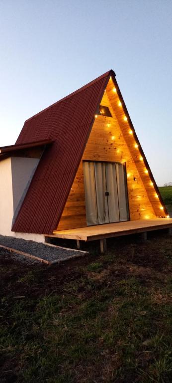 a house with a pitched roof with a door at Chalé do Campo in Palmeira