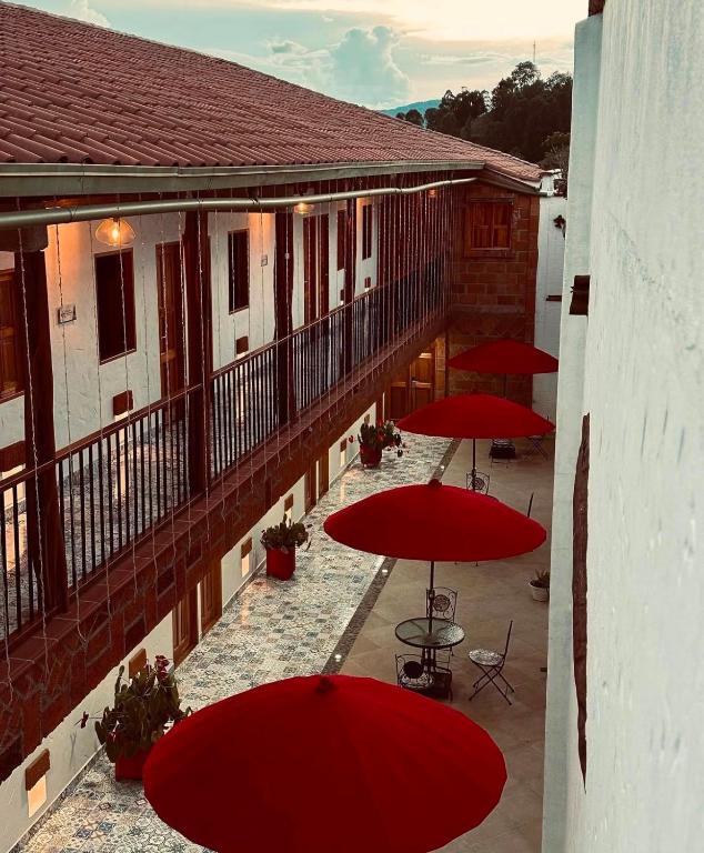 a group of red umbrellas on a balcony at Hotel Santa Laura in Jericó