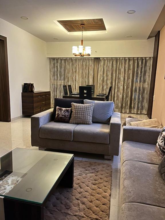 a living room with a couch and a table at Spacious 4 BHK flat- 4 Beds in Indore