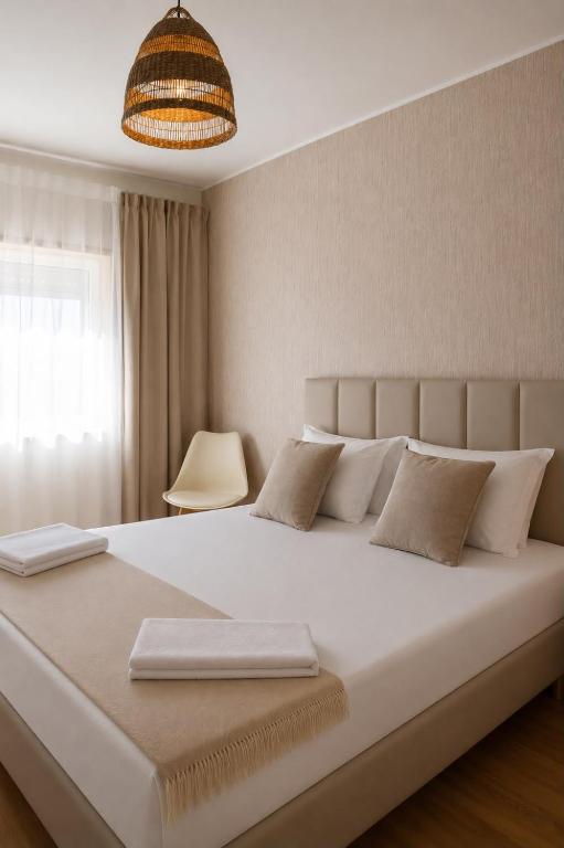 a large white bed in a room with a window at Casa do Pirata by GuestPro in Matosinhos