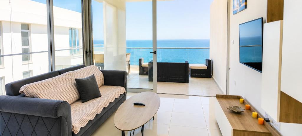 a living room with a couch and a table at Healthy Apartments Abelia Residence in Iskele