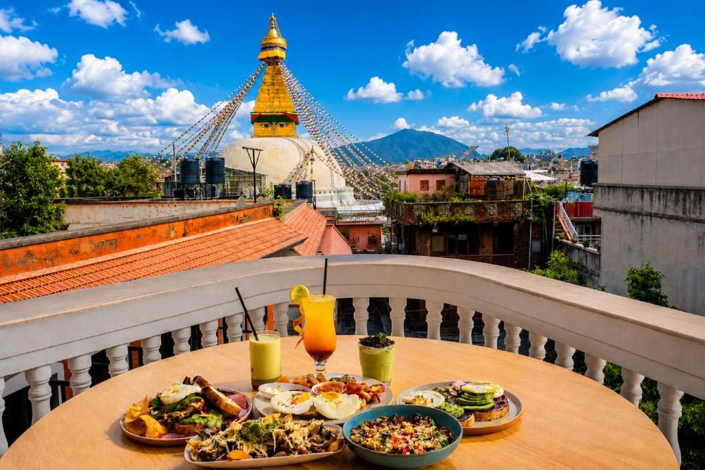 a table with food on a balcony with a view at Boudha Mandala Hotel in Kathmandu