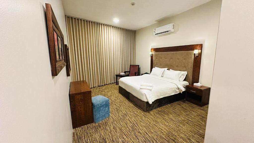 a hotel room with a bed and a chair at Dome Al Sulaimaniah in Riyadh