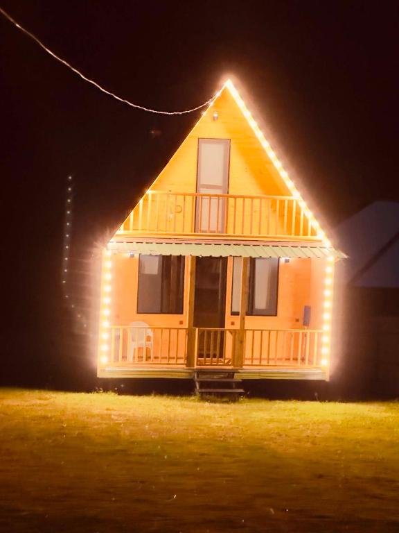 a house with lights on the front of it at night at Pine House Borjomi , Mountain View in Borjomi