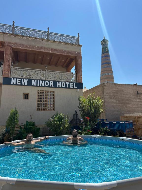 two people in a swimming pool at a new mirror hotel at New Minor Hotel in Khiva