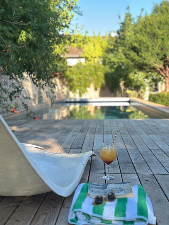 a drink and a plate of food on a table at La Maison du 19 in Cluny