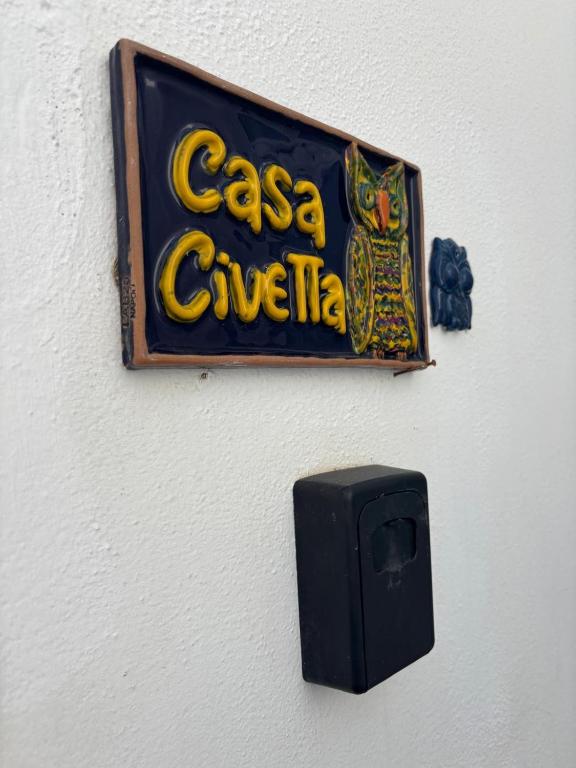 a sign for a casa giveuana hanging on a wall at Casa Civetta in Stromboli