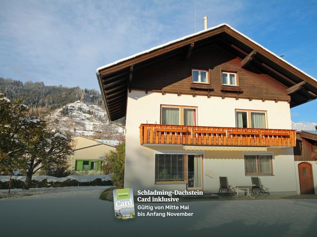 a house with a wooden balcony on the side of it at Appartement Wartinger by Schladming-Appartements in Schladming