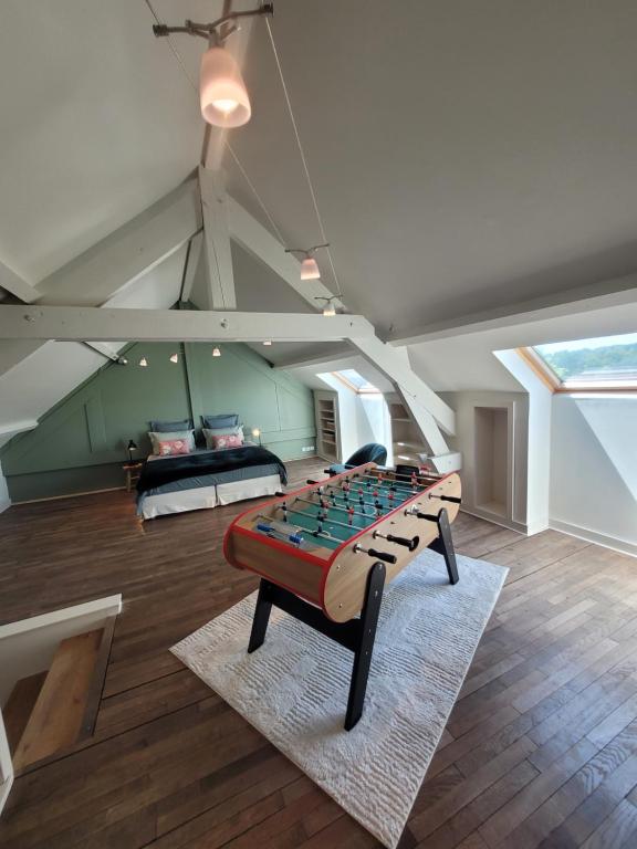 a large room with a bed and a table at L'Annexe de Steph in Loulans-Verchamp