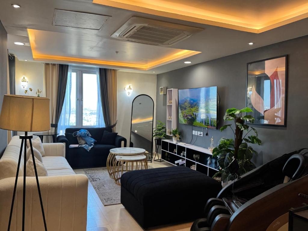 a living room with a couch and a table at Gold Crest Signature Boutique Apartments With City Views -DHA PHASE 4 LAHORE in Lahore
