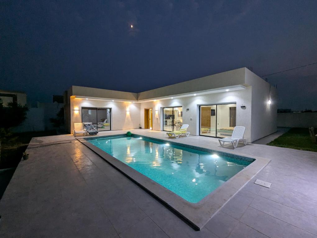 a swimming pool in the backyard of a house at Azmouni in Midoun