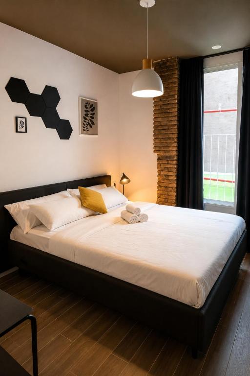 a bedroom with a large bed with white sheets at Musa in Valencia