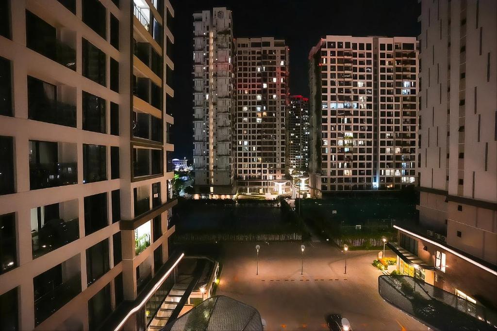 a view of a city at night with tall buildings at Ataraxia Residences in Gò Công