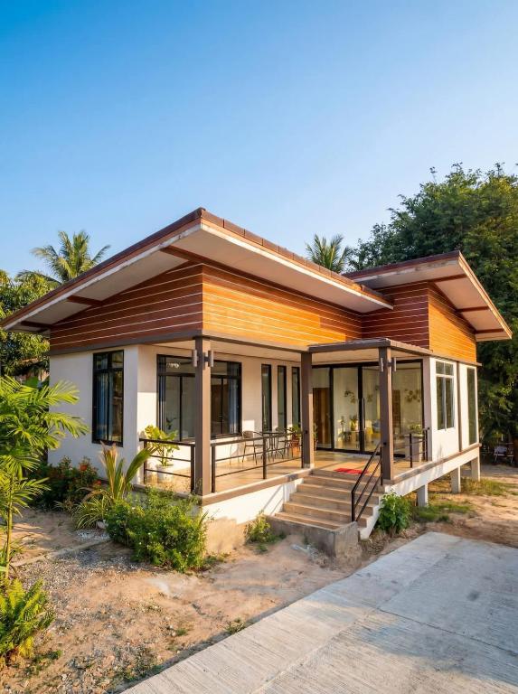 a small home with a porch and stairs to it at Srithanu sea Villa in Srithanu