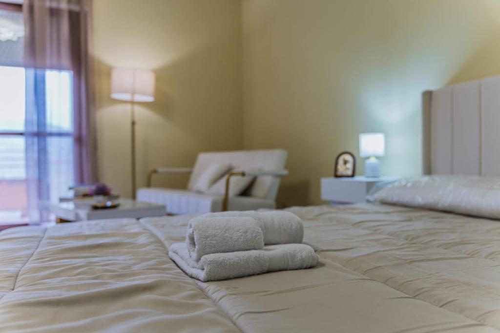 a large bed with two towels on top of it at Gold House in Lungro
