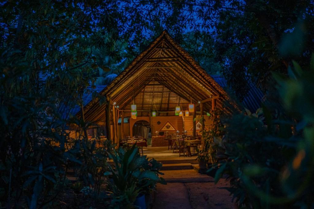 a wooden cabin in the woods at night at A4 By Gabaa in Habarana