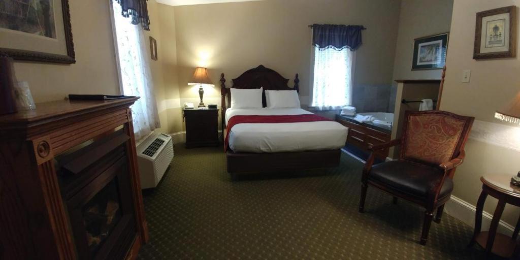 a hotel room with a bed and a desk and chair at The Inn at Jim Thorpe in Jim Thorpe