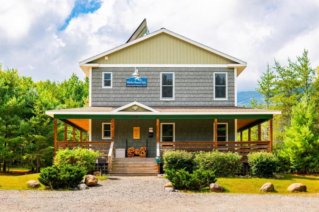 a house with a sign on the front of it at Large Luxury Home, Close to Whiteface, Lake Placid in Wilmington