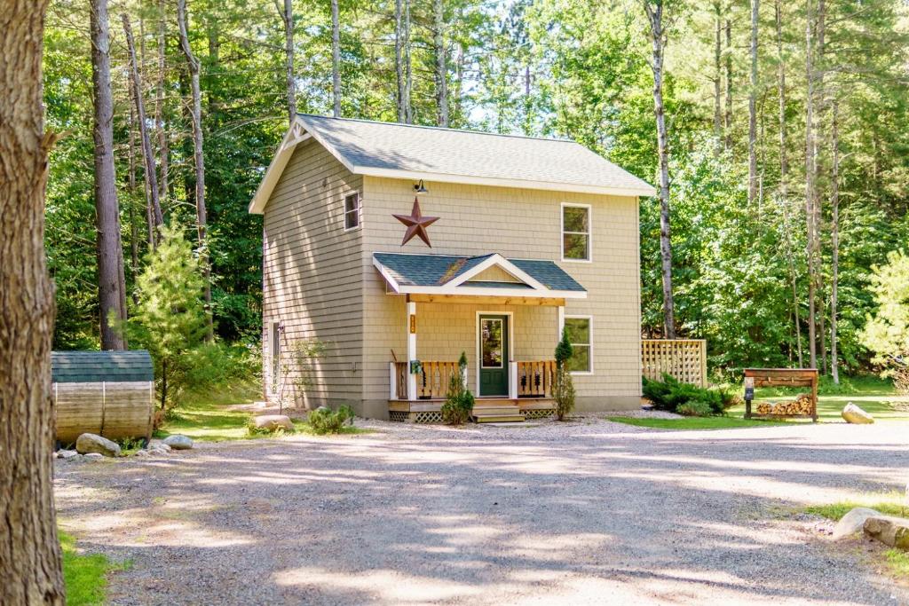 a small house in the middle of a forest at Adirondack Retreat Near Whiteface and Lake Placid in Wilmington