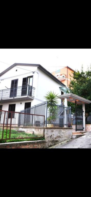 a white house with a fence in front of it at Petrucci House in Vasto