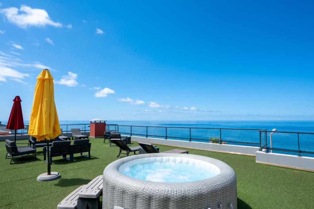 a hot tub on the roof of a building at Villa do Paul by LovelyStay in Paul do Mar