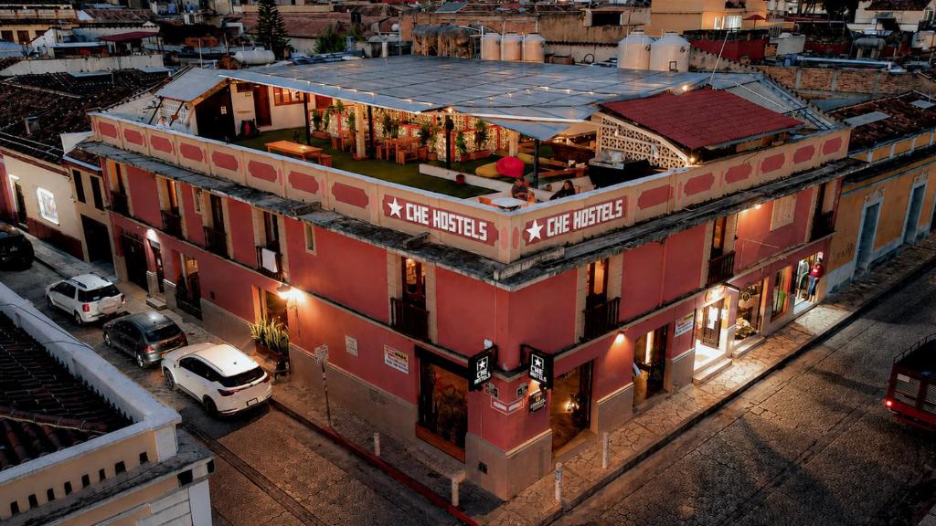 a large red building on a city street at night at Che San Cristobal de las Casas Hostel in San Cristóbal de Las Casas