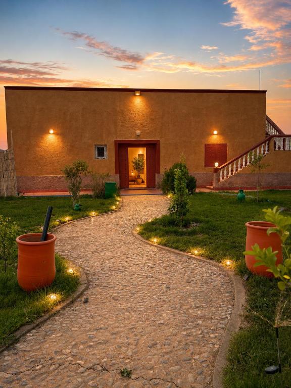 a stone walkway with lights in front of a building at Dar Said Marrakech in Lalla Takerkoust