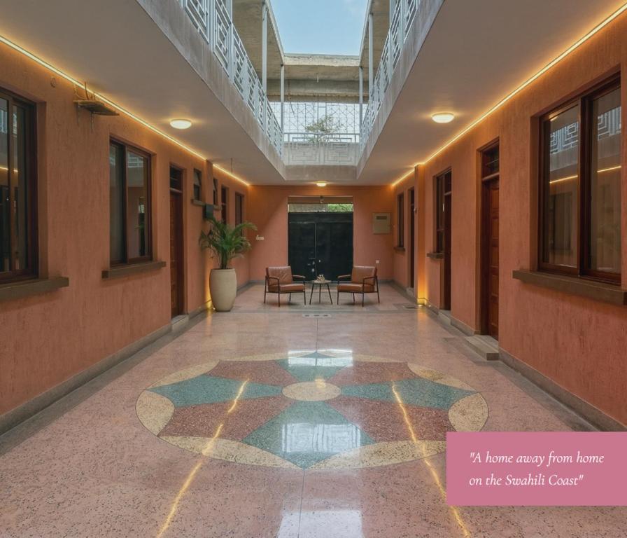 a hallway of a building with a table and chairs at Mama Maendeleo Resort in Hindi