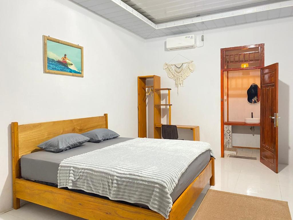 a bedroom with a bed in a room at Surak Villa Mentawai in Katiet
