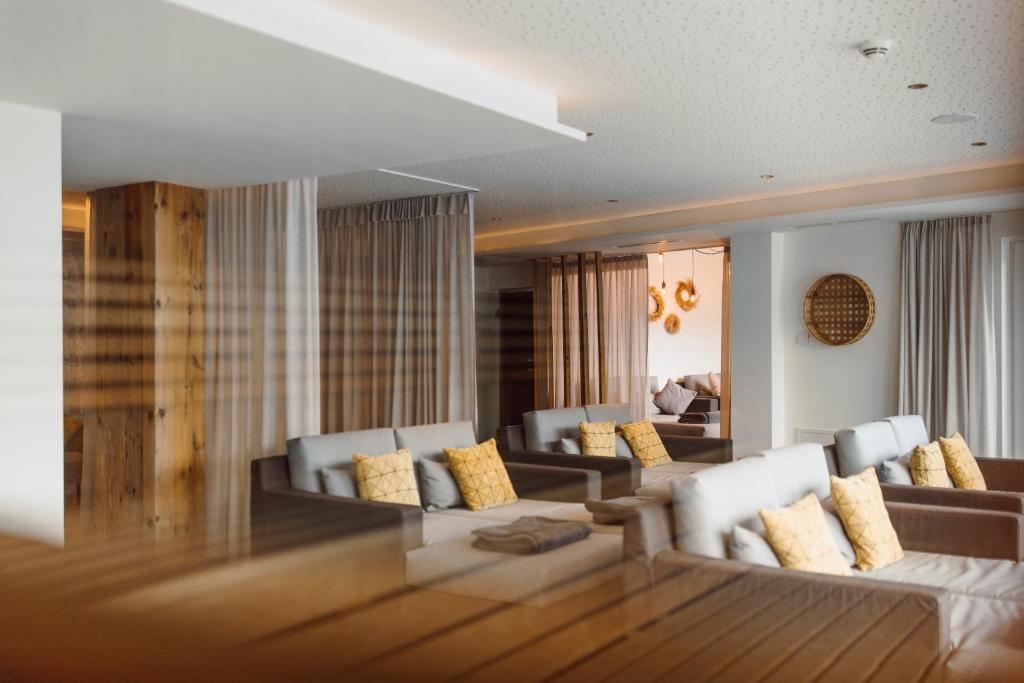 a living room with couches and a dining room at Rohrmooser Schlössl in Schladming
