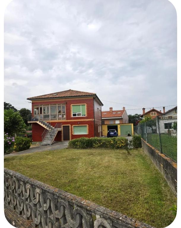 a house with a large yard in front of it at El Rincón de pedreña in Pedreña