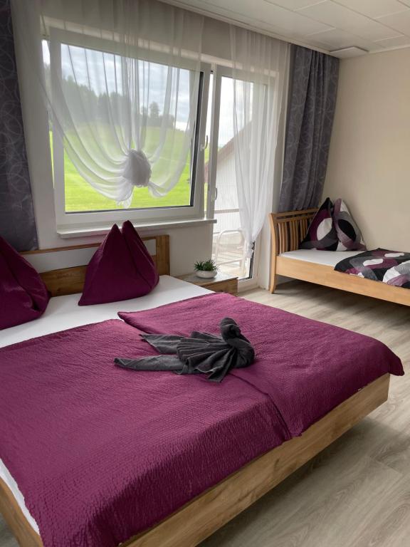 a bedroom with a large purple bed with a window at Haus Lisa in Kroisbach