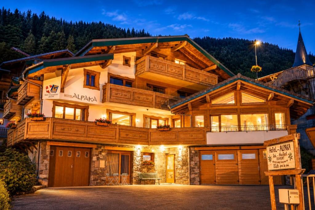 a house in the mountains with a garage at Chalet Hotel Alpaka in Châtel