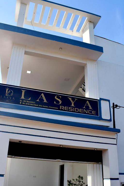 a blue sign on the side of a building at Lasya Residence in Trincomalee