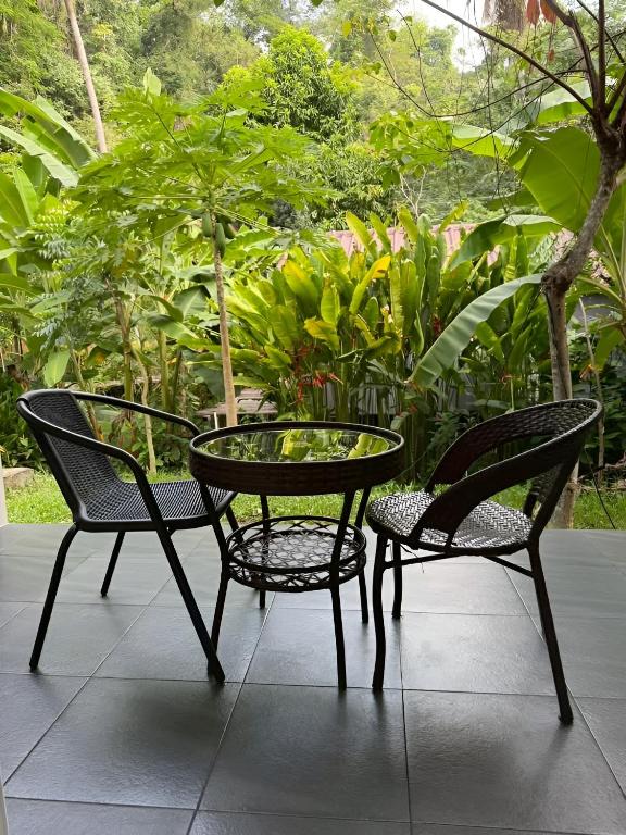 two chairs and a table and a table and two chairs at Zerohouse in Ban Bang Bao