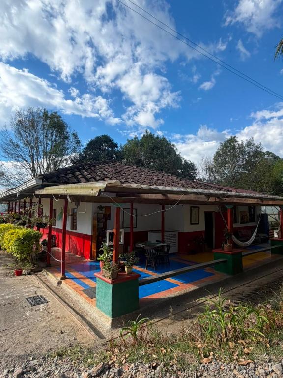 a small white house with a red roof at Eco Finca El Regalo in Salento