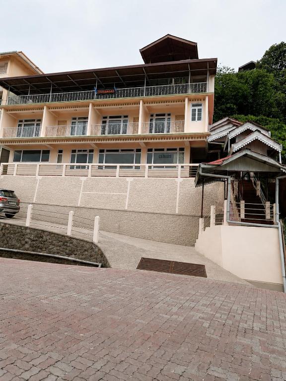 a large building with a car parked in front of it at CLOUDS Hotel and restaurant in Gangtok