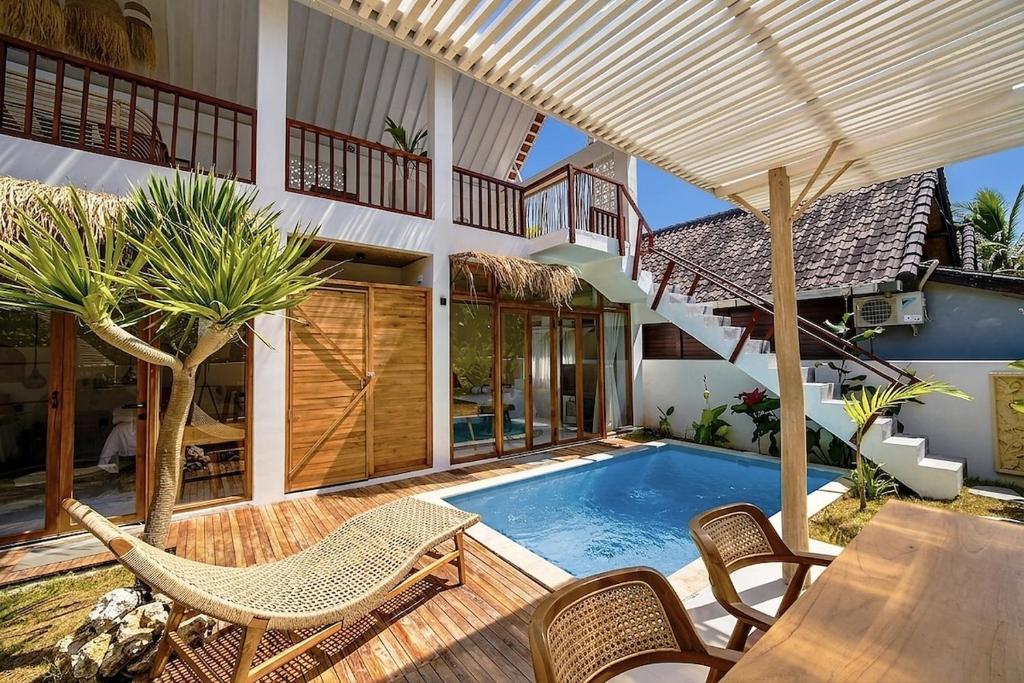 an outdoor patio with a swimming pool and a house at 2BR, Private Pool, Prime Location, Tropikarma in Toyapakeh