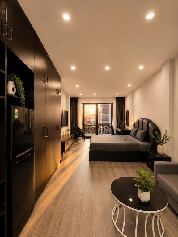 a living room with a bed and a couch at Sora Westlake - Modern Apartment with Balcony in Hanoi