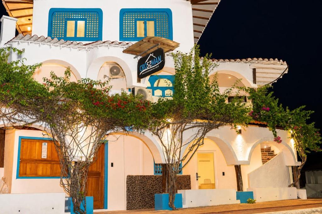 a building with trees in front of it at Hotel Crossman in Puerto Ayora