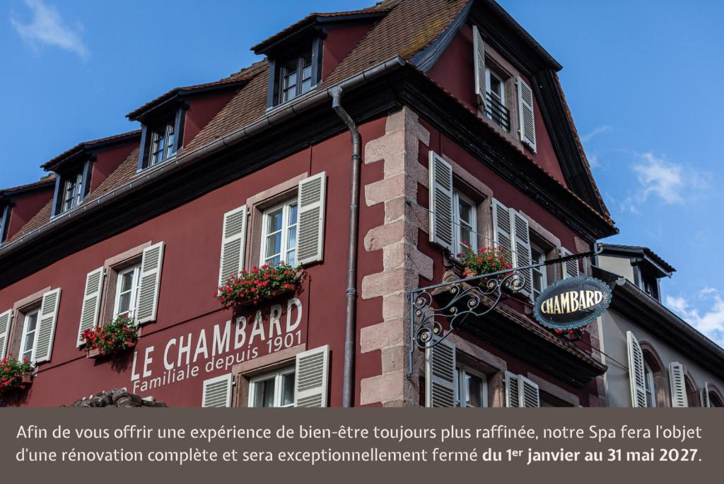a red building with a sign on the side of it at Relais et Châteaux Le Chambard in Kaysersberg