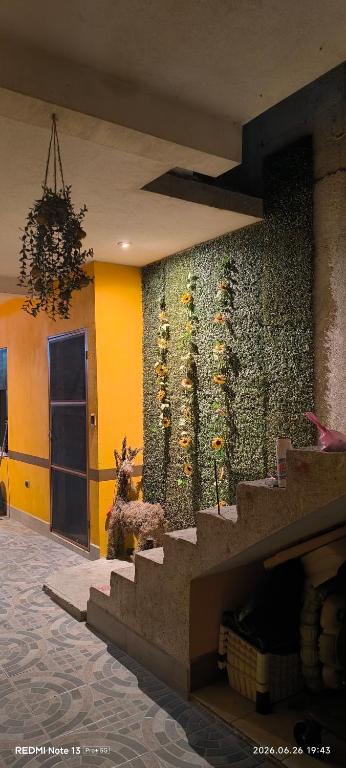 a wall with sunflowers on it in a building at La Casa Amarilla in Sololá
