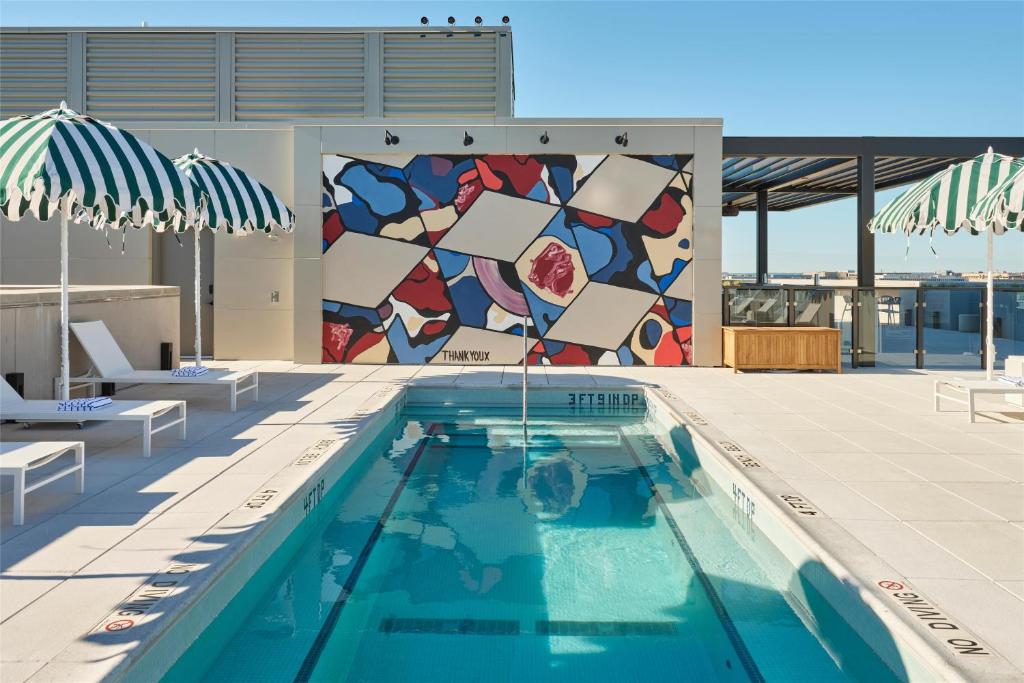 a pool with a mosaic wall on a building at Arlo Washington DC in Washington, D.C.